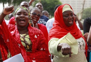 Women shout slogans during a rally calling on the Government to rescue the school girls kidnapped from the Chibok Government secondary school in Abuja, Nigeria, Sunday May 11, 2014. The failure to rescue the kidnapped girl students who remain captive after some four weeks has attracted mounting national and international outrage, and one of the teenagers who escaped from the Islamic extremists who abducted the hundreds of schoolgirls, science student Sarah Lawan said Sunday in an interview with The Associated Press the kidnapping was "too terrifying for words". (AP Photo/Sunday Alamba)