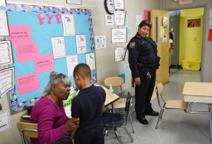 BALTIMORE, MD - NOVEMBER 05: Fourth grade substitute teacher, Doris Cook, left, talks to student, JaRon Jordan as school police officer, Tiffany Wiggins is seen at right at Thomas Jefferson Elementary /Middle School on Thursday November 05, 2015 in Baltimore, MD. Wiggins, who works through the school district patrols several schools. (Photo by Matt McClain/ The Washington Post)