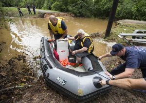 Conroe firefighters evacuate Jim Treadway via boat after Treadway was stranded when Pecan Bend Road was washed out  near the San Jacinto River on Friday, May 27, 2016, in Conroe, Texas. ( Brett Coomer/Houston Chronicle via AP) MANDATORY CREDIT