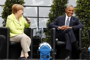 German Chancellor Angela Merkel and former U.S. President Barack Obama attend a discussion at the German Protestant Kirchentag in front of the Brandenburg Gate in Berlin, Germany, May 25, 2017. REUTERS/Fabrizio Bensch