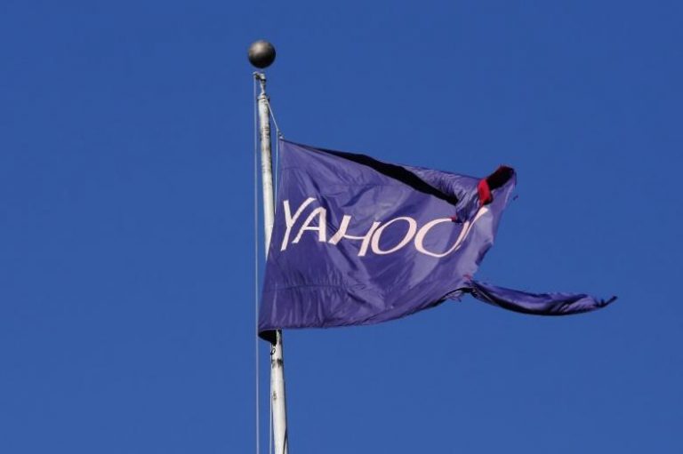 FILE PHOTO: A tattered flag bearing the Yahoo company logo flies above a building in New York, U.S., October 31, 2016. REUTERS/Lucas Jackson